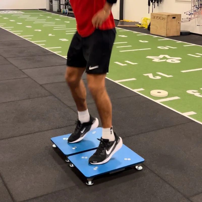 Athlete standing on the two PlateMate plates, ready to jump