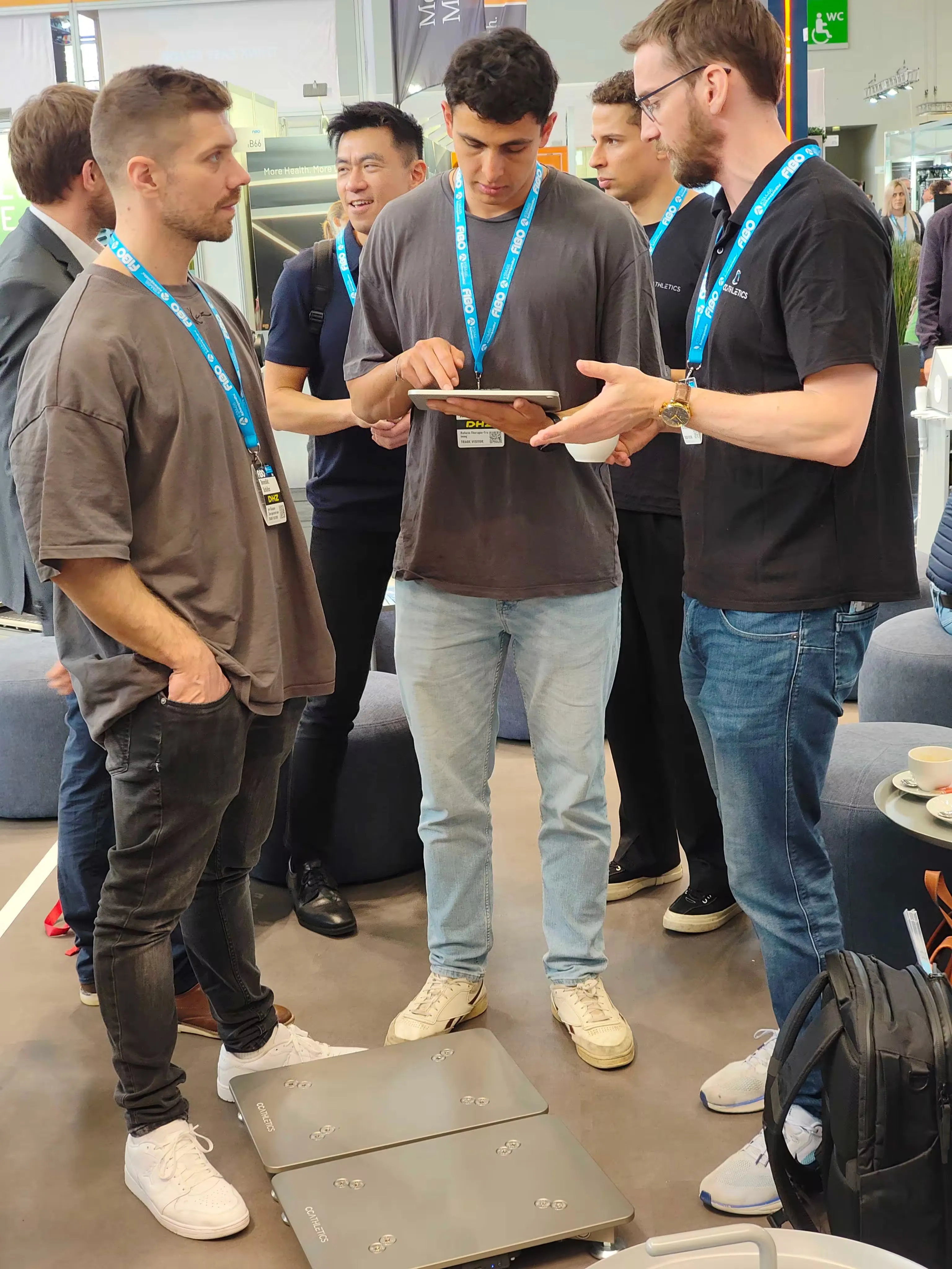 The CC Athletics team demoing force plates and the app to visitors at a trade show.